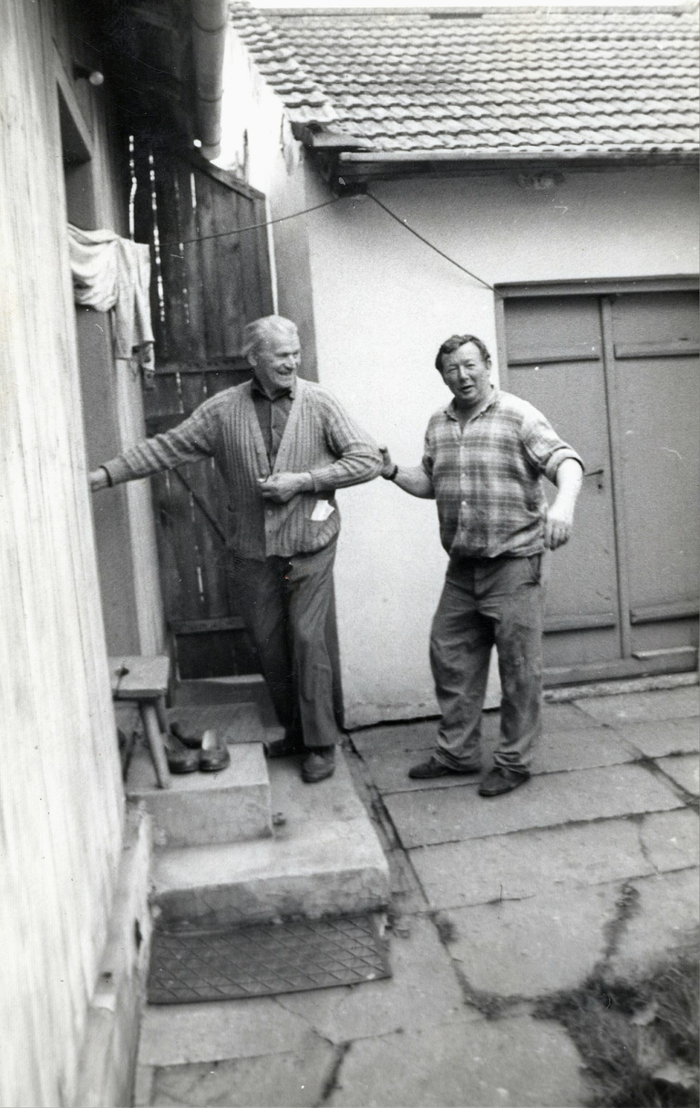 Śp. panowie J. Rząsa i M. Wszoła przed wejściem do drewnianego domu przy ulicy Witosa 2 w Głogowie.